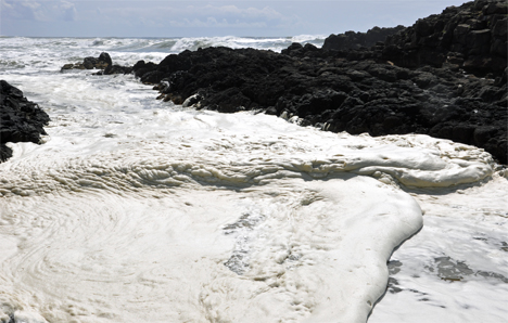 the waves and froth enter from the left