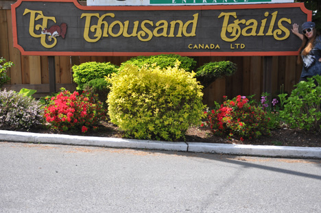 Karen Duquette at the Thousand Trails entrance sign