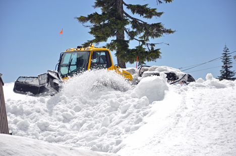 A SNOW PLOW HARD AT WORK ON GROUSE MOUNTAIN