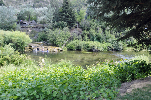 People in the Portneuf River behind the RV of the two RV Gypsies