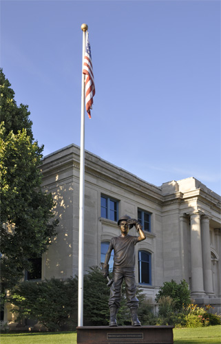 Hard Hat Kid sculpture and USA flag