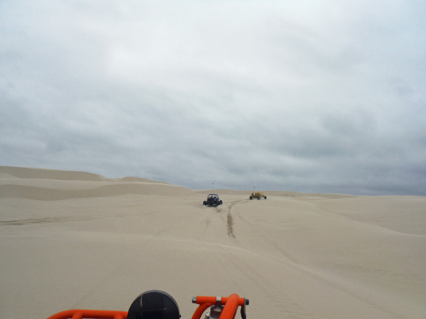 Dune buggies heading up the dune