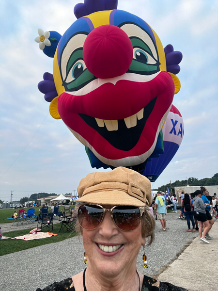 The giant clown balloon snuck-up behind Karen Duquette