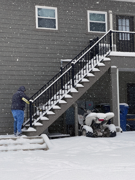 Alex Jones removing snow from stairs