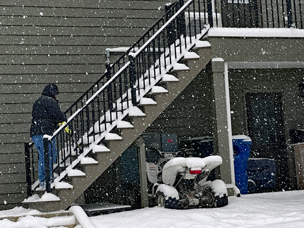 Alex Jones removing snow from stairs