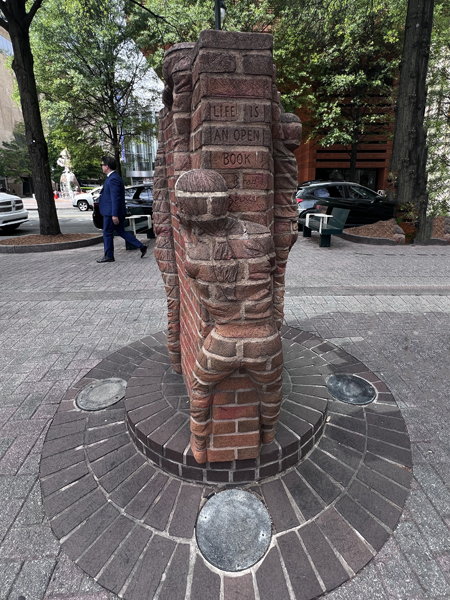 Boys climbing a brick wall