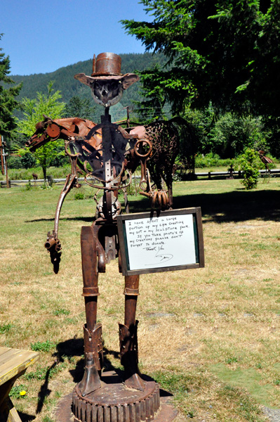 donation request sculpture with sign asking for donations