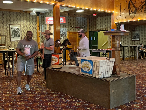 grown men riding stick horses