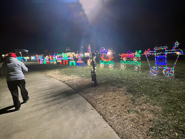 Lee Duquette walking by the very long train in lights